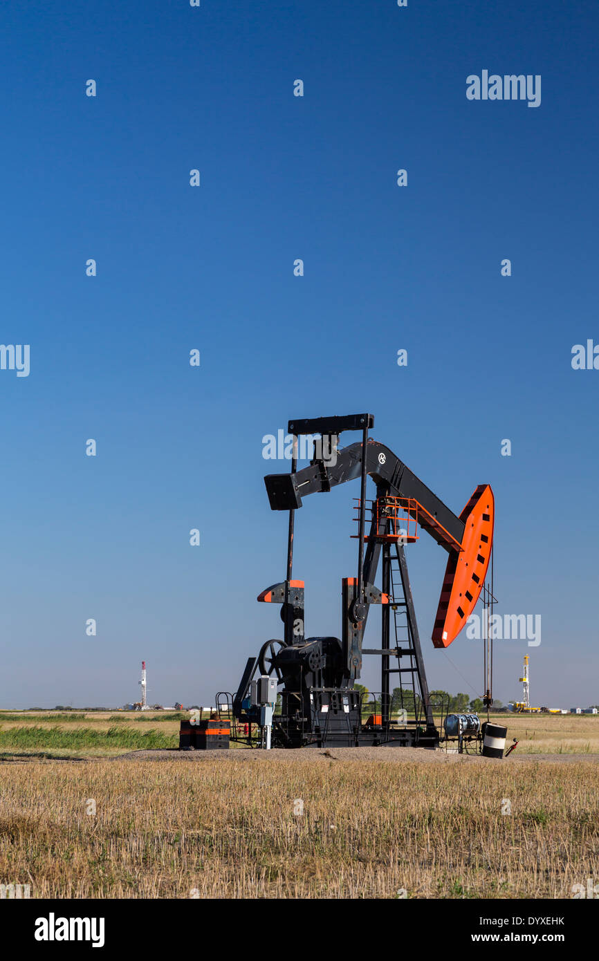 An oil production pumper in the Bakken field near Stoughton, Saskatchewan, Canada. Stock Photo