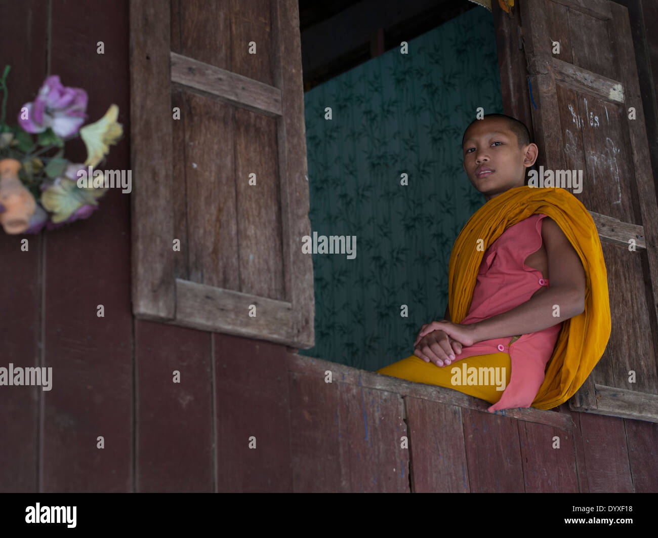 Young Monk in window, Angkor Wat, Siem Reap, Cambodia Stock Photo