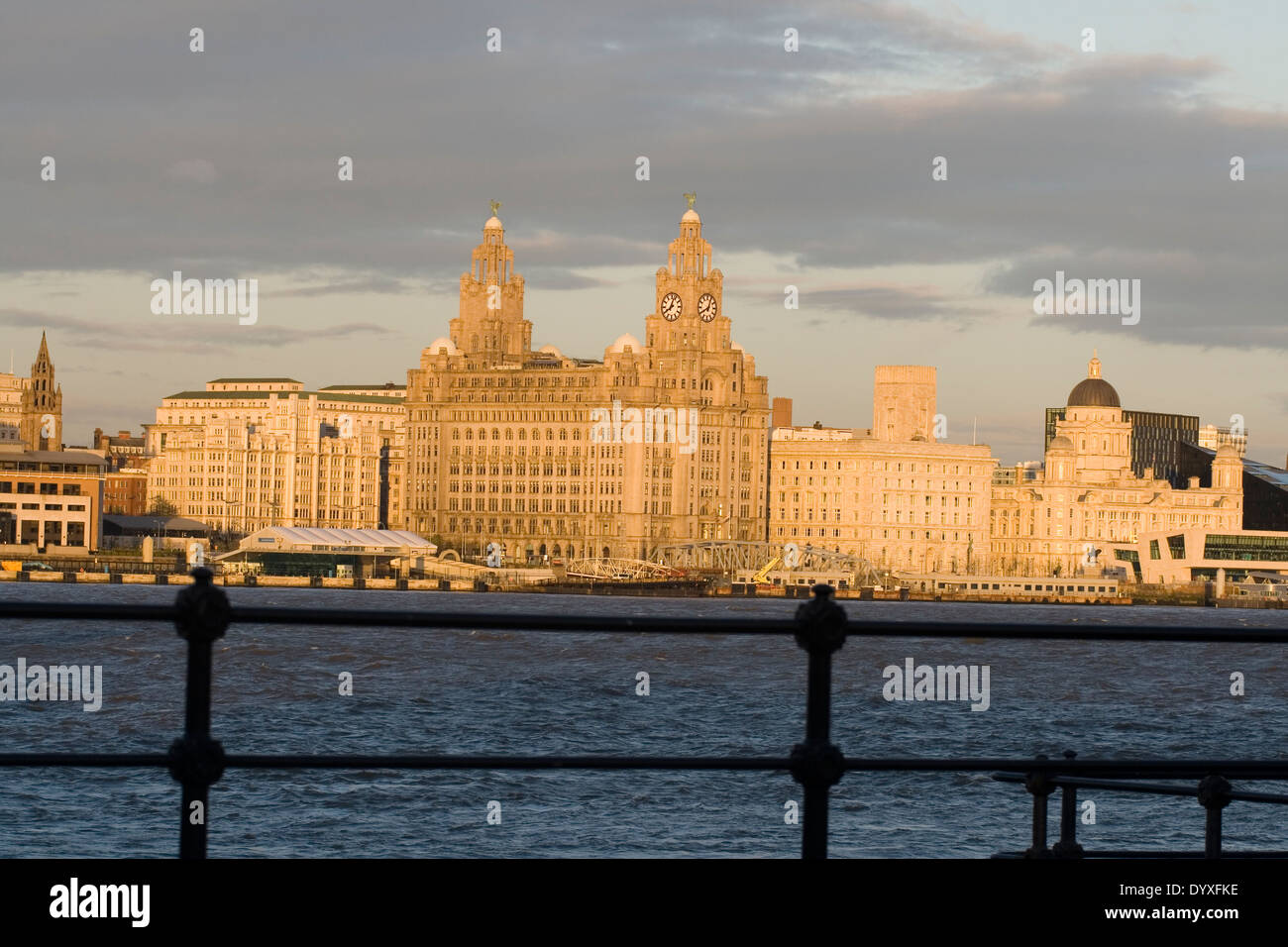 looking over the river mersey at the liver building as the sun is setting Stock Photo