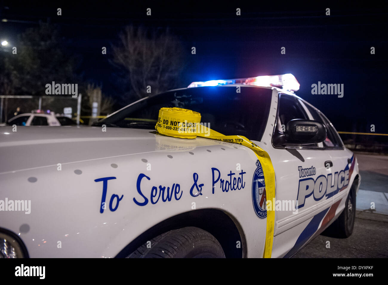 A roll of crime scene tape sits on the hood of a Toronto police car Stock Photo
