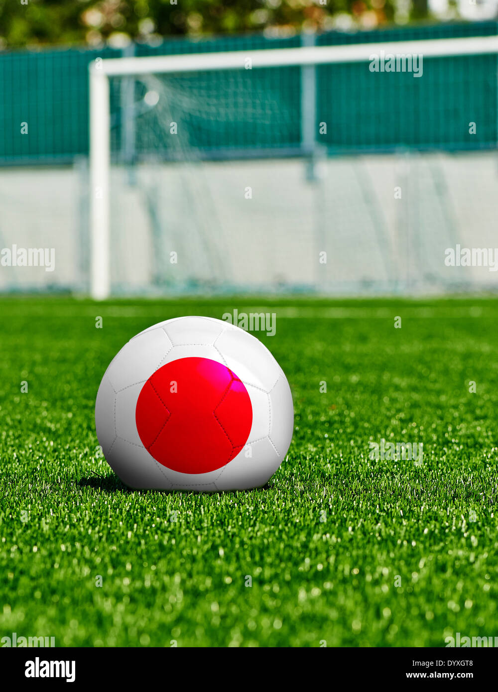Soccer Ball with Japan Flag on the grass in stadium Stock Photo