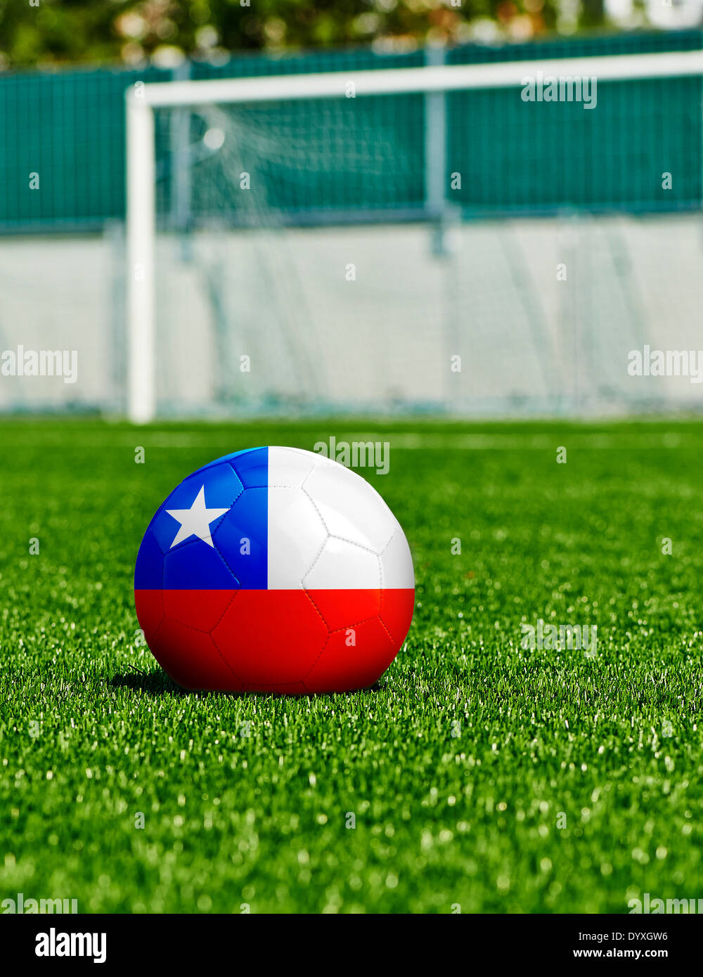 Soccer Ball with Chile Flag on the grass in stadium Stock Photo