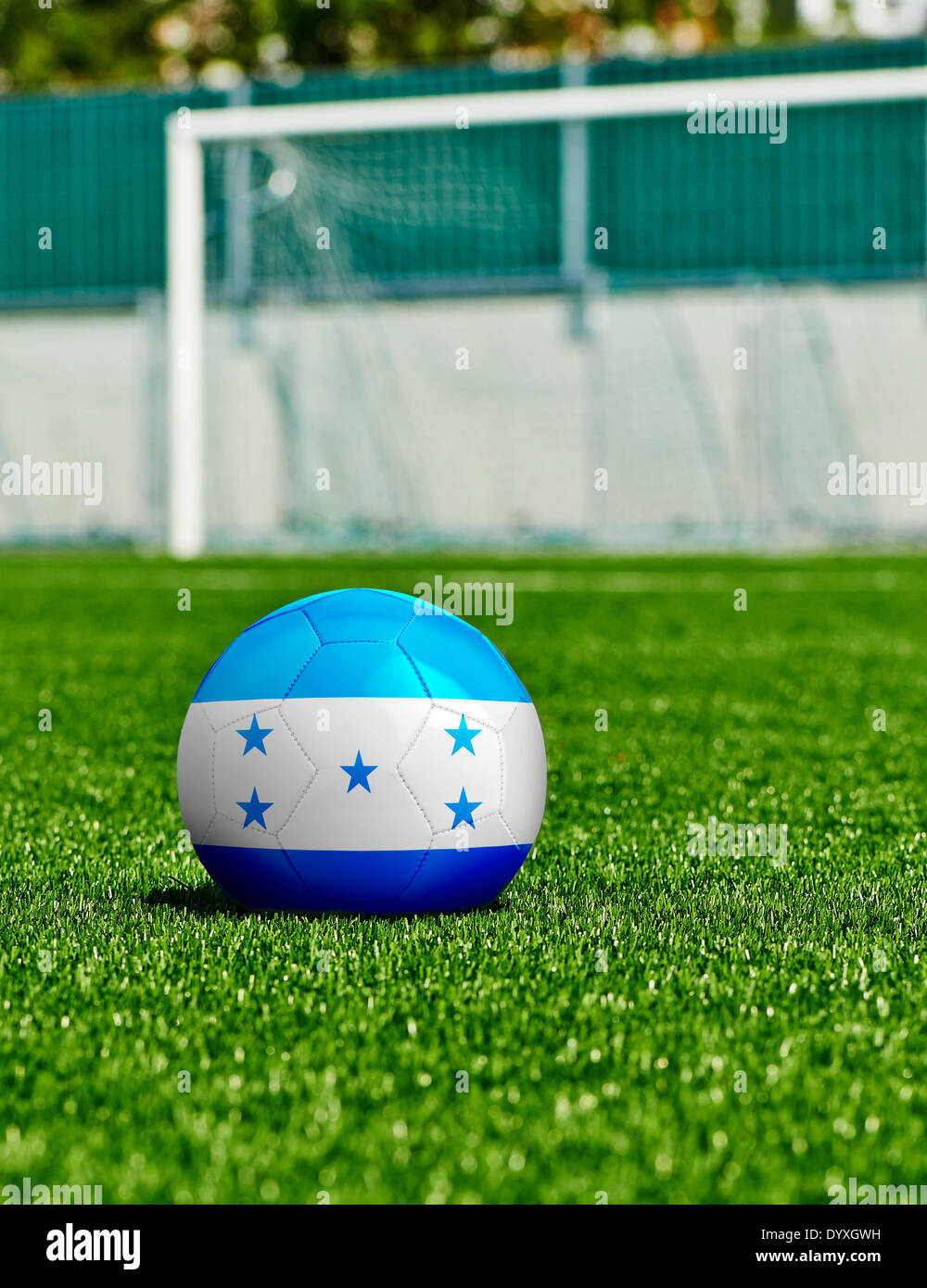 Soccer Ball with Honduras Flag on the grass in stadium Stock Photo
