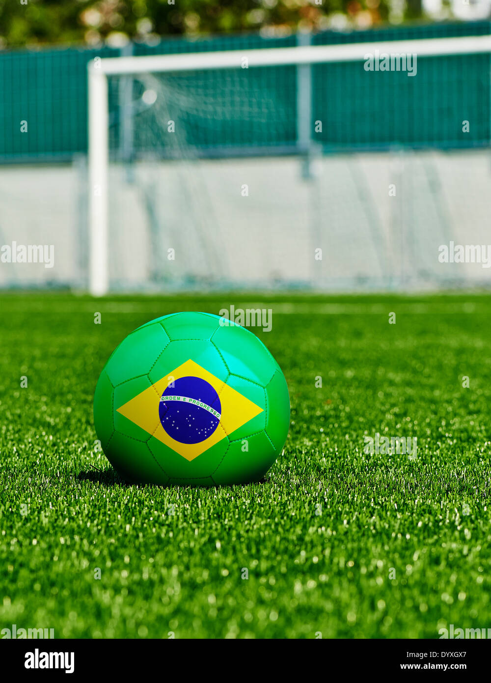 Soccer Ball with Brazilian Flag on the grass in stadium Stock Photo