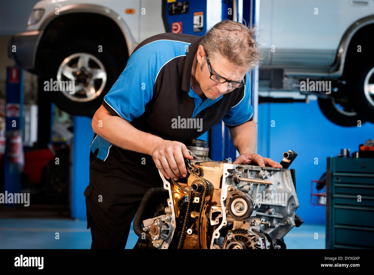 Mechanic working on a car engine Stock Photo