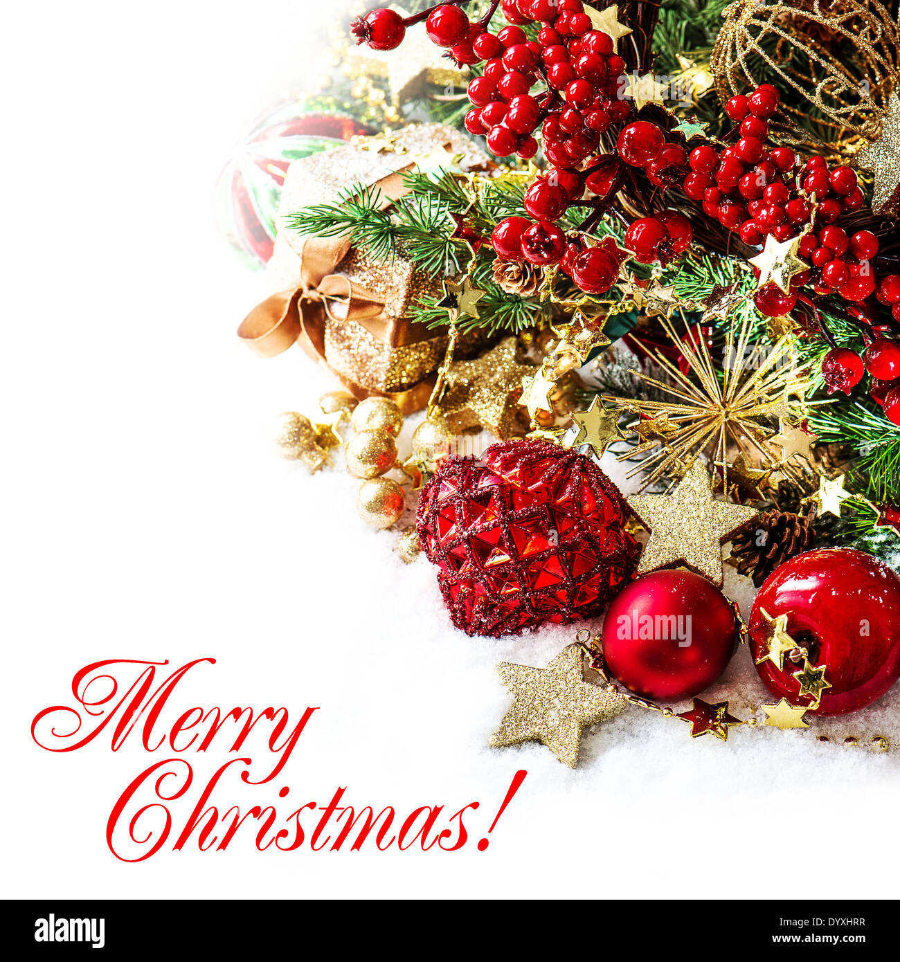 festive decoration with baubles, golden garlands, christmas tree and red berries. Stock Photo