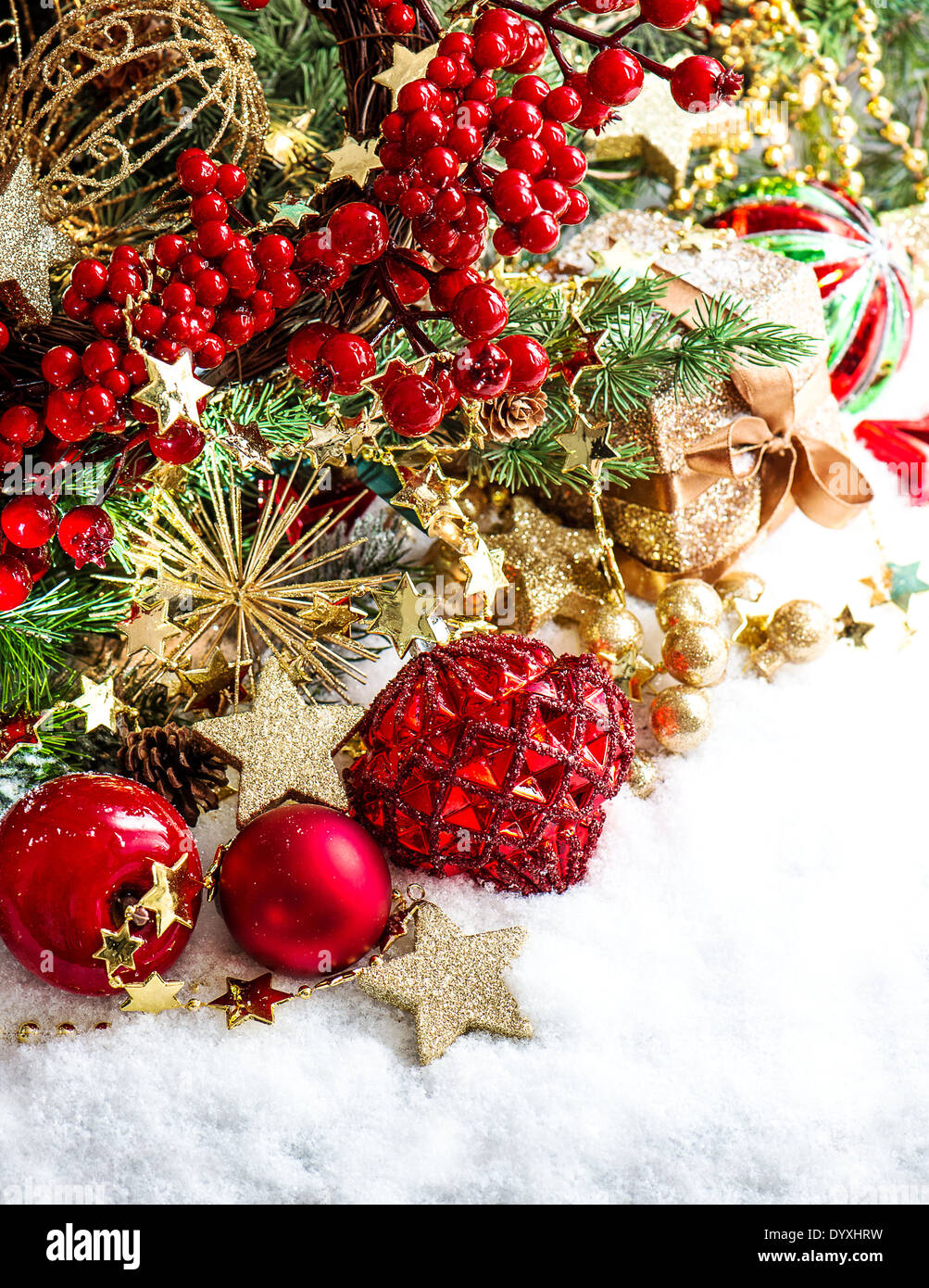 festive decoration with baubles, golden garlands, christmas tree and red berries Stock Photo