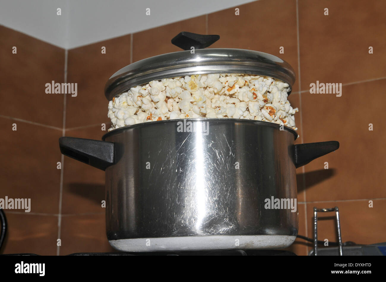 A pot of pop corn on a gas stove Stock Photo - Alamy