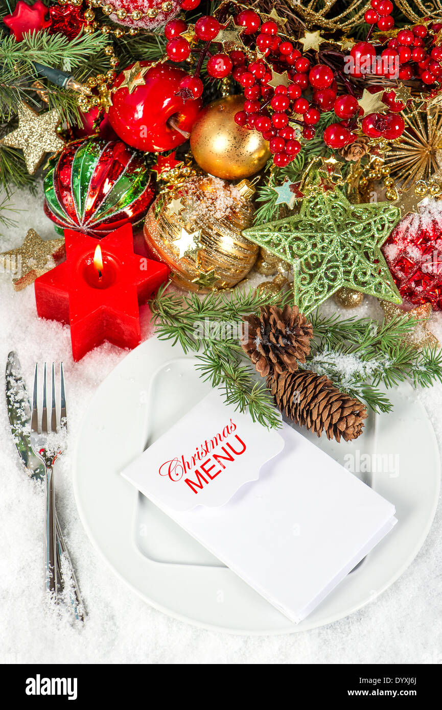 festive christmas table place setting decoration with red candle Stock Photo