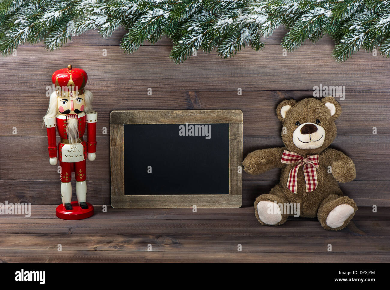 nostalgic christmas decoration with antique toys and blackboard for your text. retro style dark picture Stock Photo
