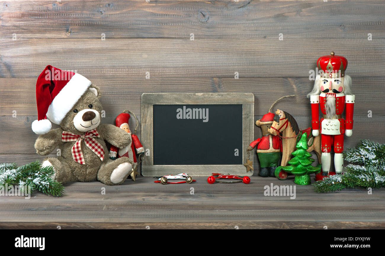 nostalgic christmas decoration with antique toys and blackboard for your text. retro style toned picture Stock Photo