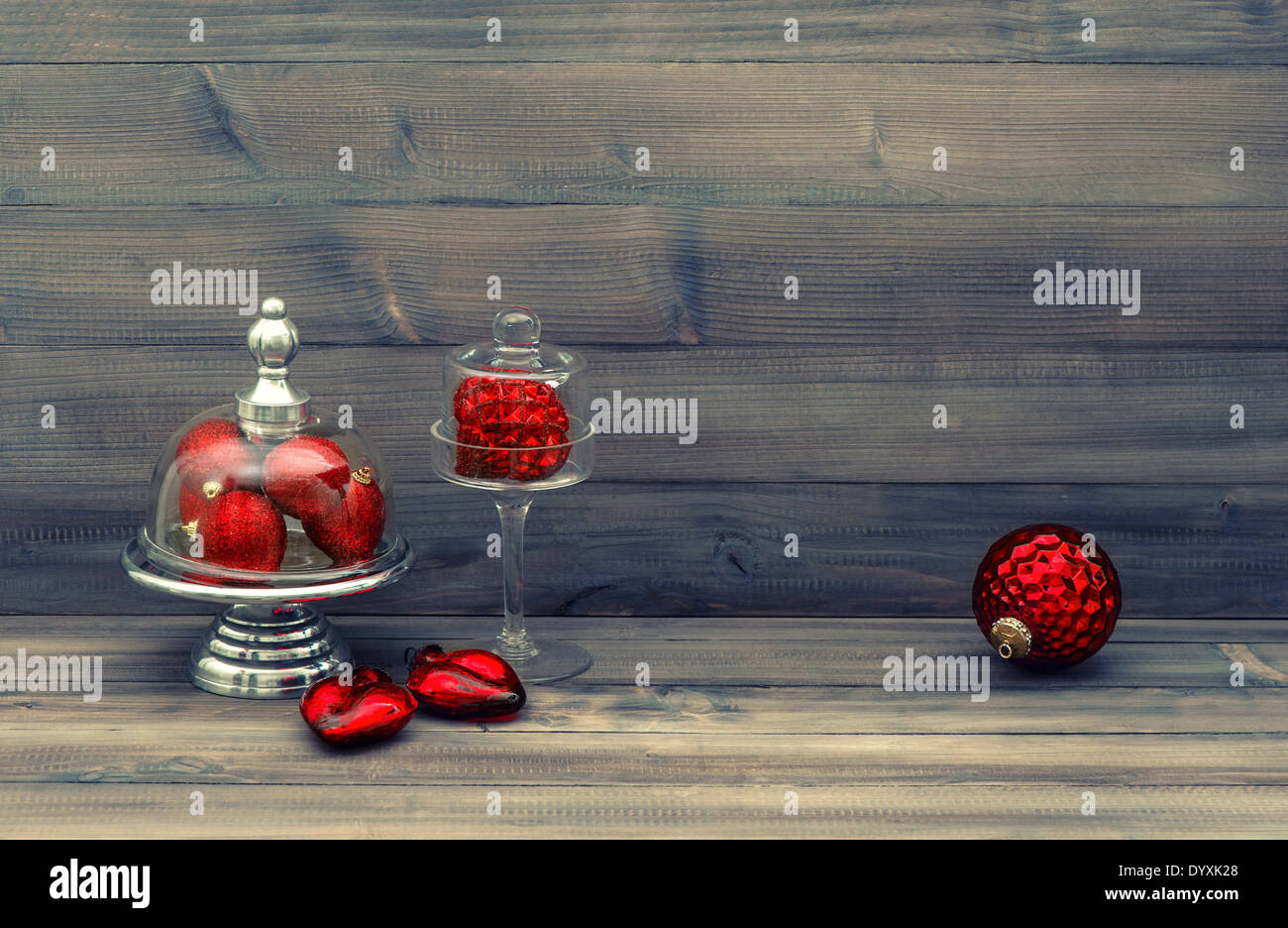 vintage style christmas decoration with red baubles over rustic wooden background. nostalgic still life Stock Photo