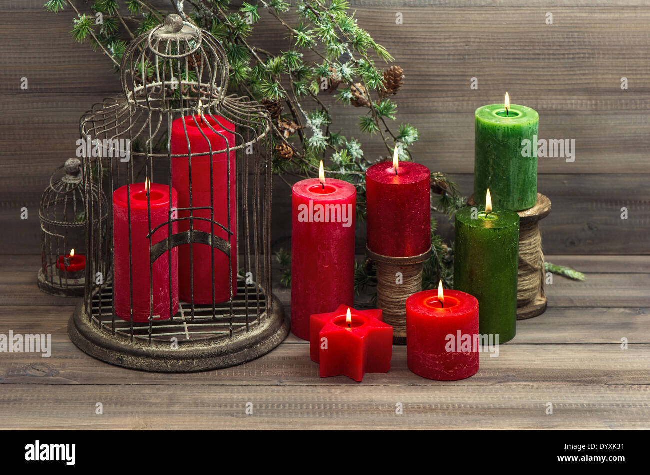 vintage christmas decoration birdcage, red candles and pine branch. nostalgic home interior Stock Photo