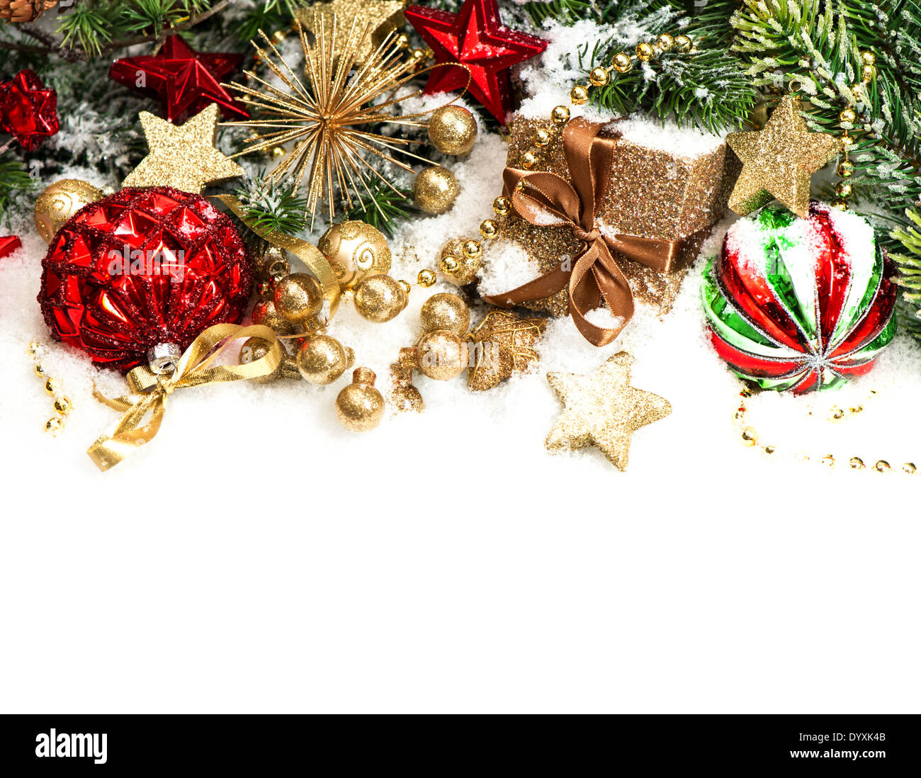christmas decorations in red, golden, green and christmas tree branches on white background Stock Photo
