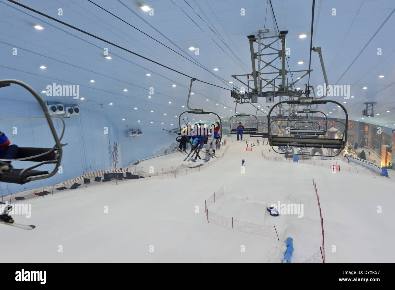 Skiers transported by ski lifts in the indoors of the Ski Dubai resort