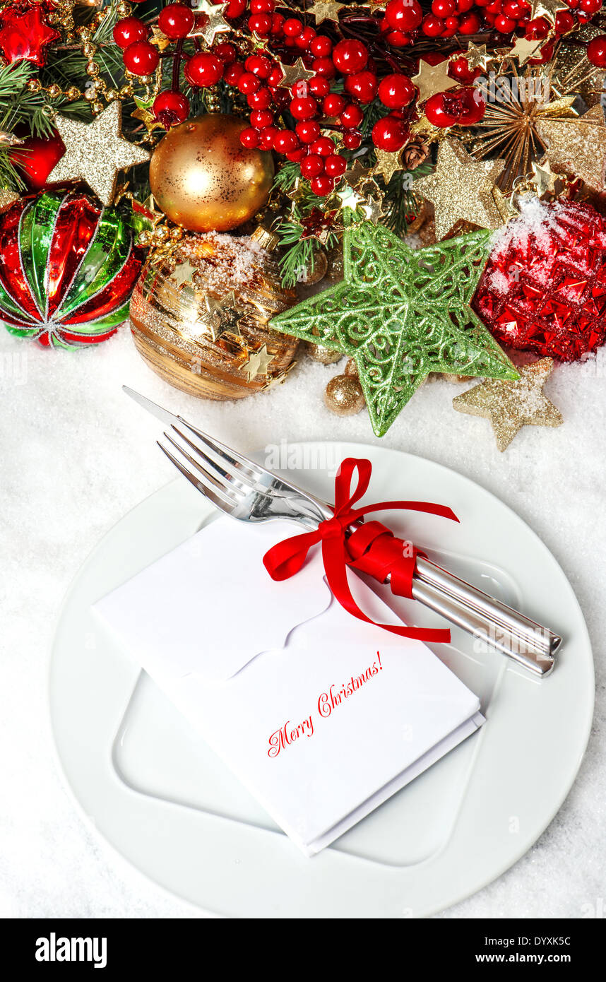 festive table place setting decoration with baubles, golden garlands, candle, Stock Photo