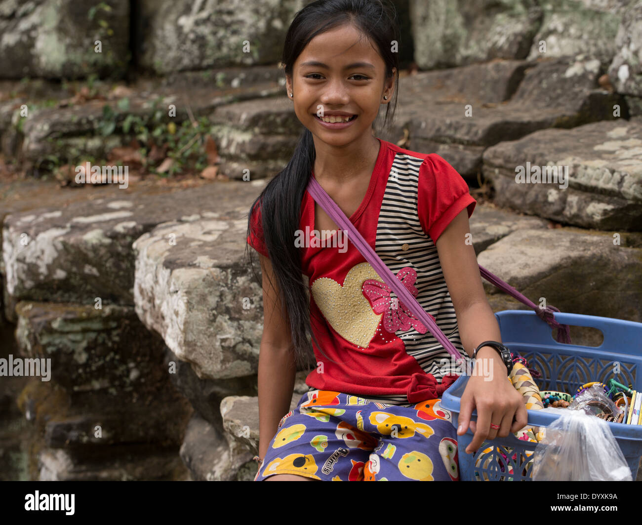 Young girl selling souvenirs at Banteay Kdei Buddhist Monastery / Temple ruins. Siem Reap, Cambodia Stock Photo