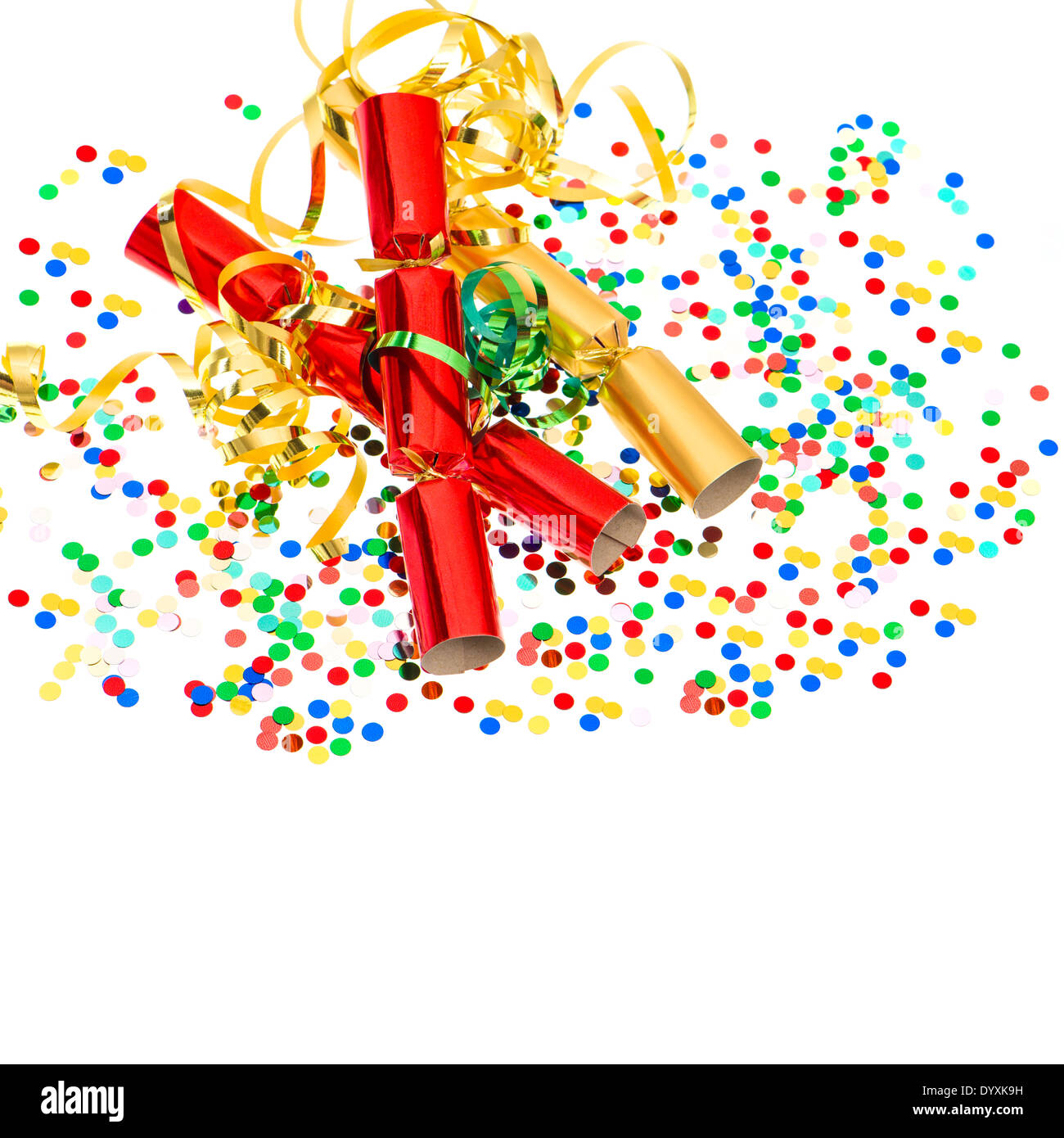 party cracker, golden streamer and confetti over white. festive decoration background Stock Photo
