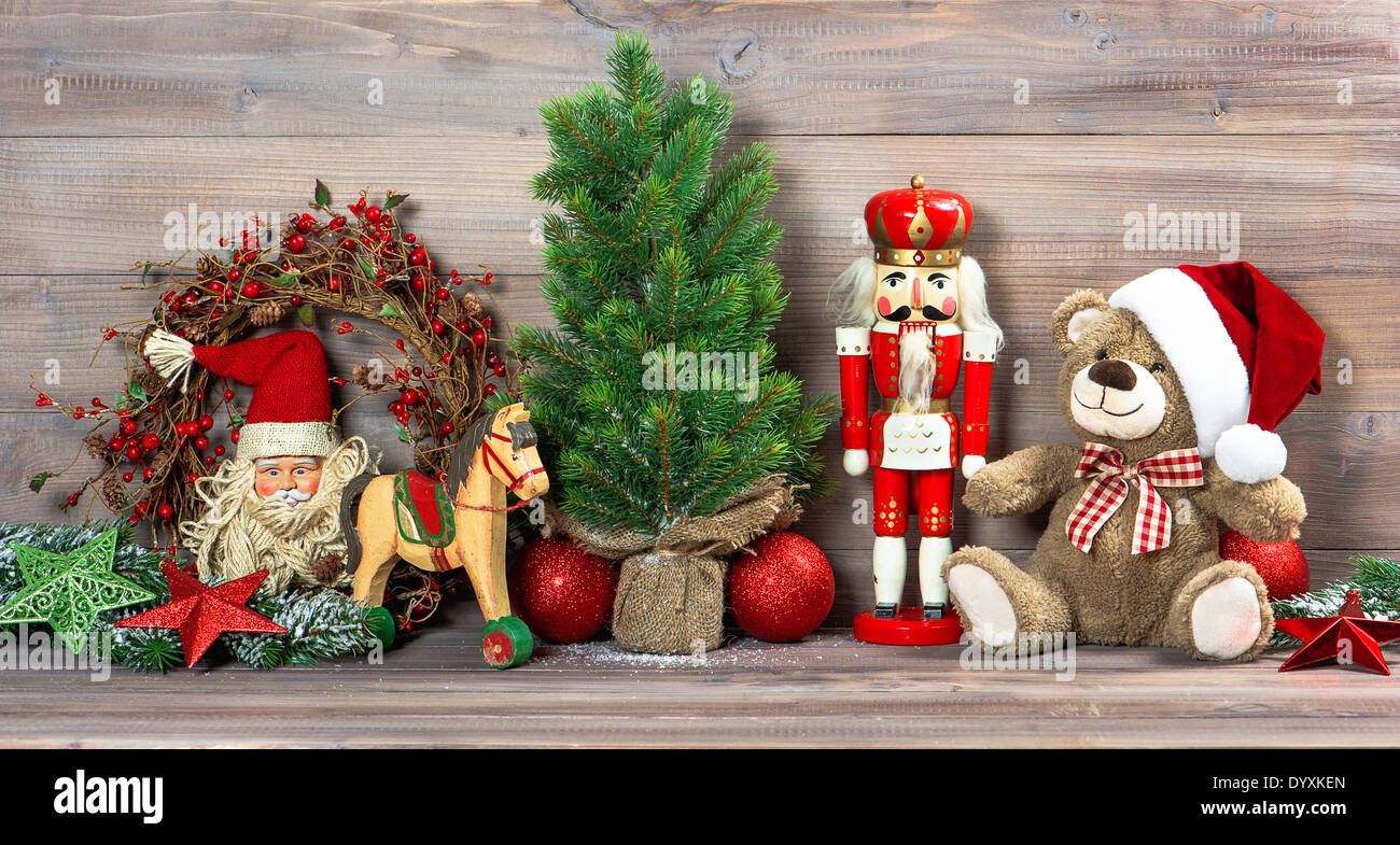 nostalgic christmas decoration with antique toys teddy bear and nutcracker. retro style picture Stock Photo