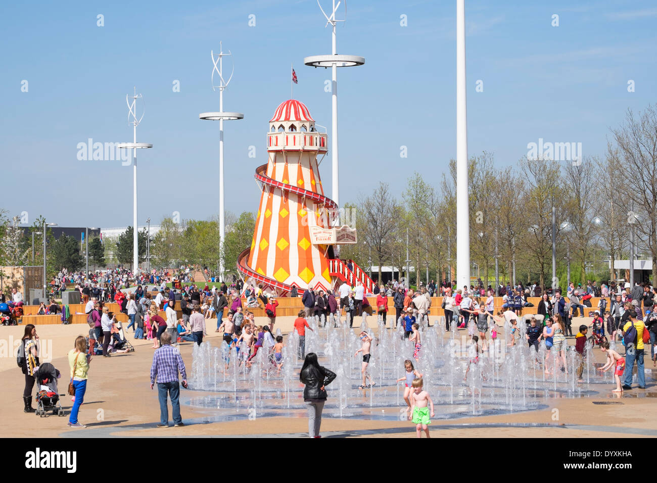 Helter Skelter funfair and fountain with many visitors at Queen Elizabeth Olympic Park in Stratford London United Kingdom Stock Photo