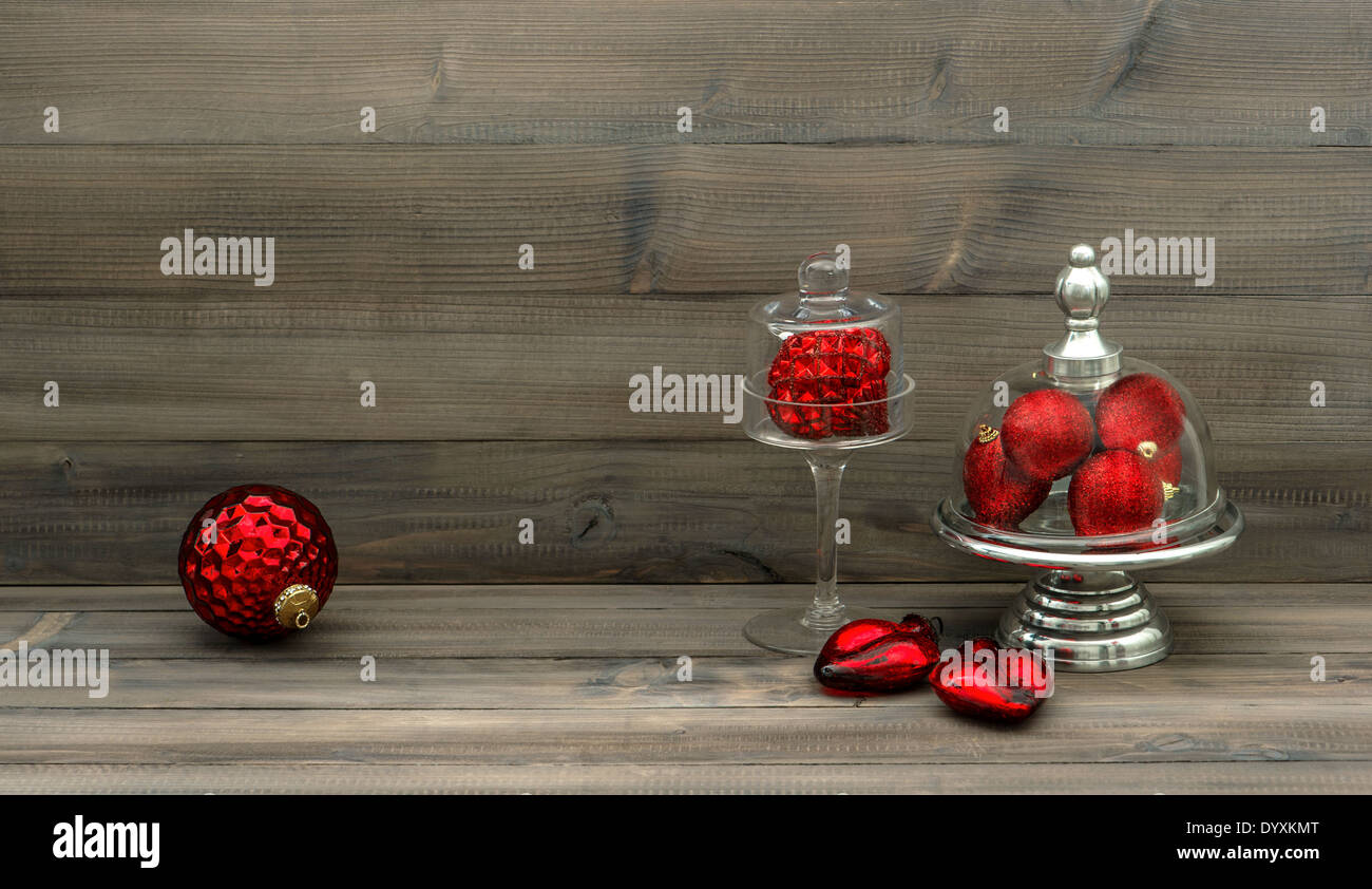 retro style christmas decoration with red baubles on rustic wooden background. nostalgic home interior Stock Photo