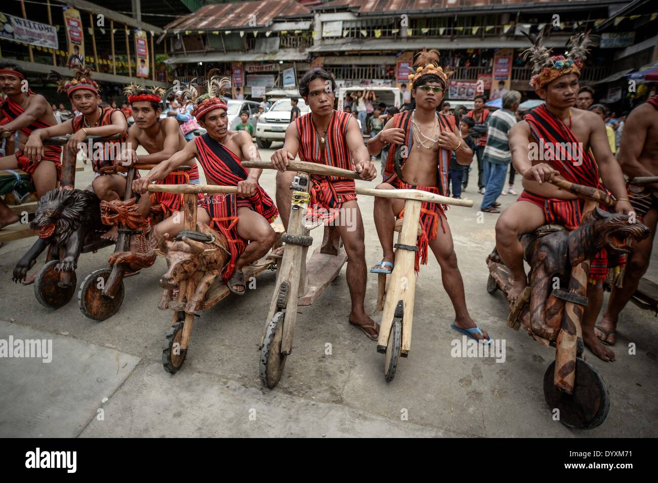 Banaue, Philippines. 27th Apr, 2014. Ifugao tribesmen ride wooden