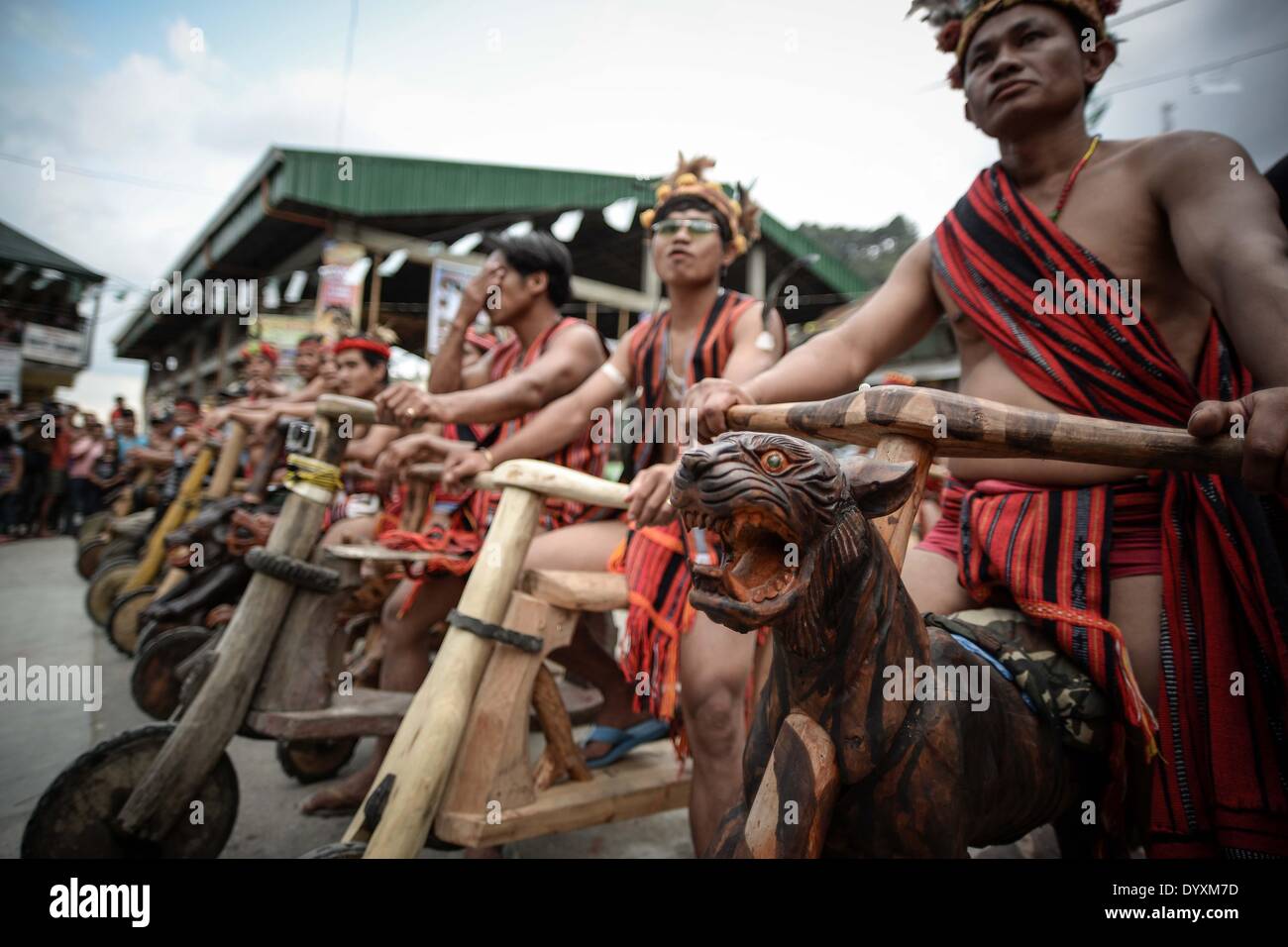 Banaue, Philippines. 27th Apr, 2014. Ifugao tribesmen ride wooden