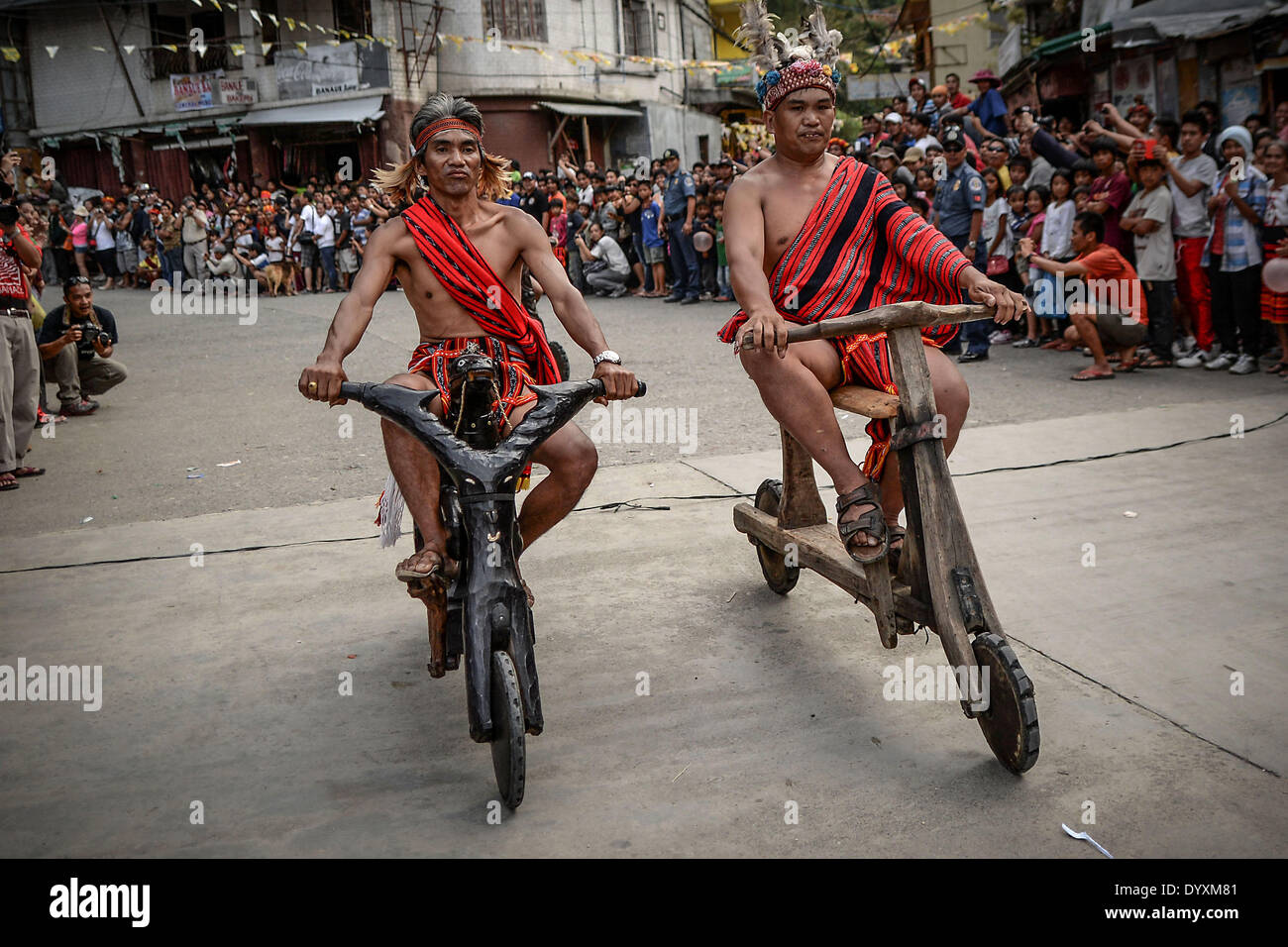 Banaue, Philippines. 27th Apr, 2014. Ifugao tribesmen ride wooden