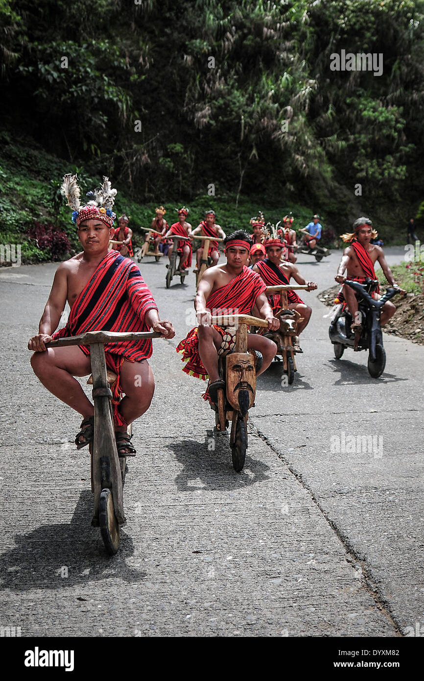Banaue, Philippines. 27th Apr, 2014. Ifugao tribesmen ride wooden