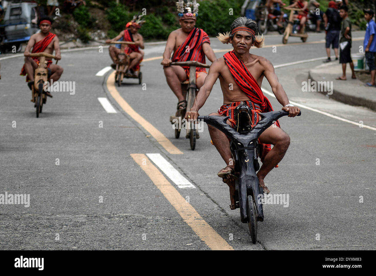 Banaue, Philippines. 27th Apr, 2014. Ifugao tribesmen ride wooden