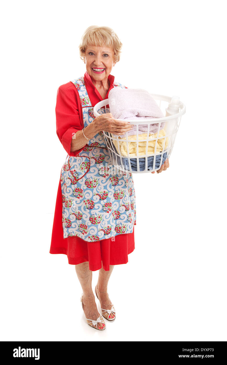 Senior woman dressed in retro fashion carrying a basket of laundry. Full body isolated.  Stock Photo