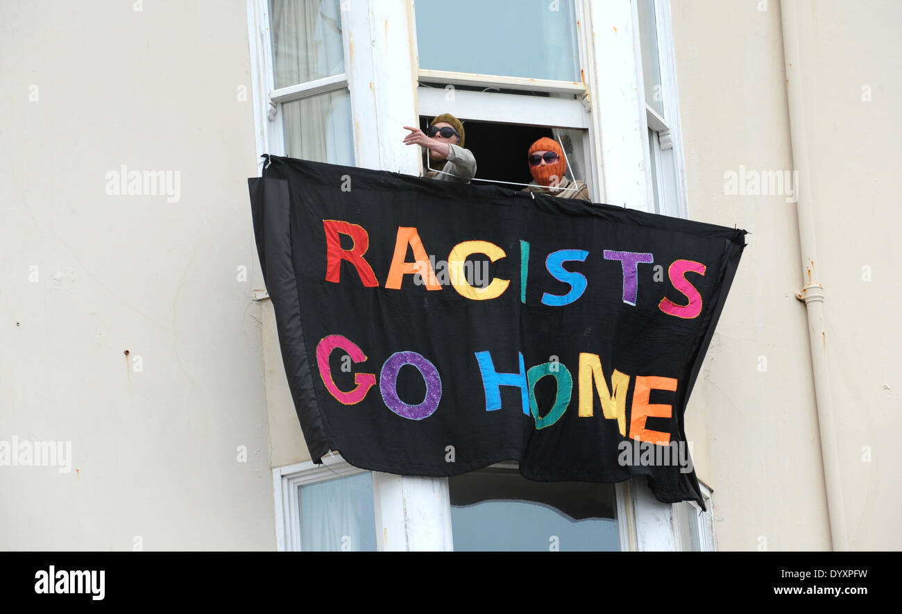 Racists Go Home -  Local residents hand out a banner at the March for England Rally in Brighton today.About 100 people took part in the rally which caused major disruption in the city with a massive police presence trying to keep anti fascist protesters away from the marchers Stock Photo