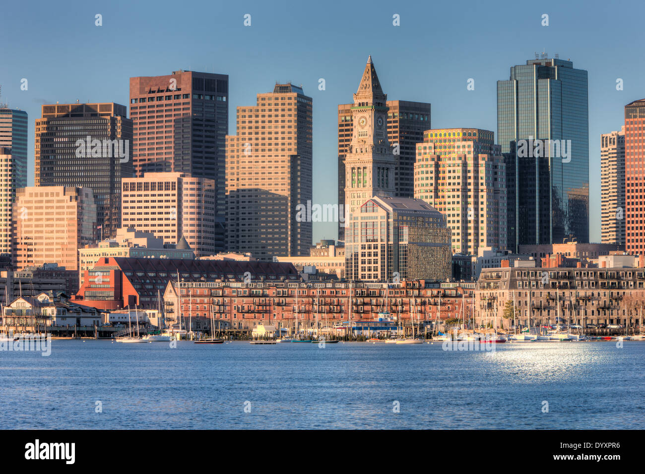A morning view of the Custom House Tower, the Financial District, and low rise wharves on the waterfront in Boston, Massachusetts. Stock Photo