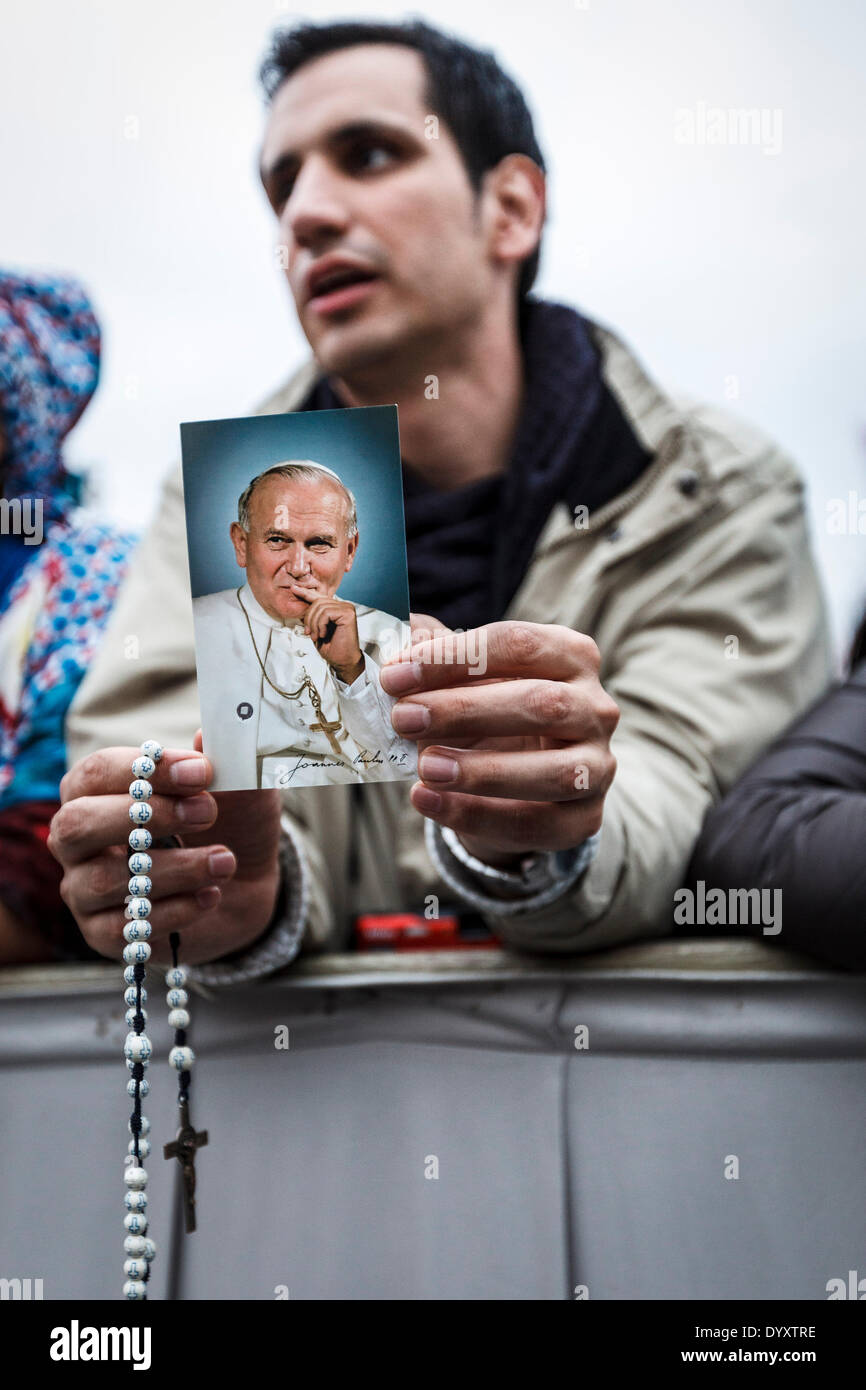 Vatican, Rome, Italy. 27th Apr, 2014. A man holds a photo of Pope John ...