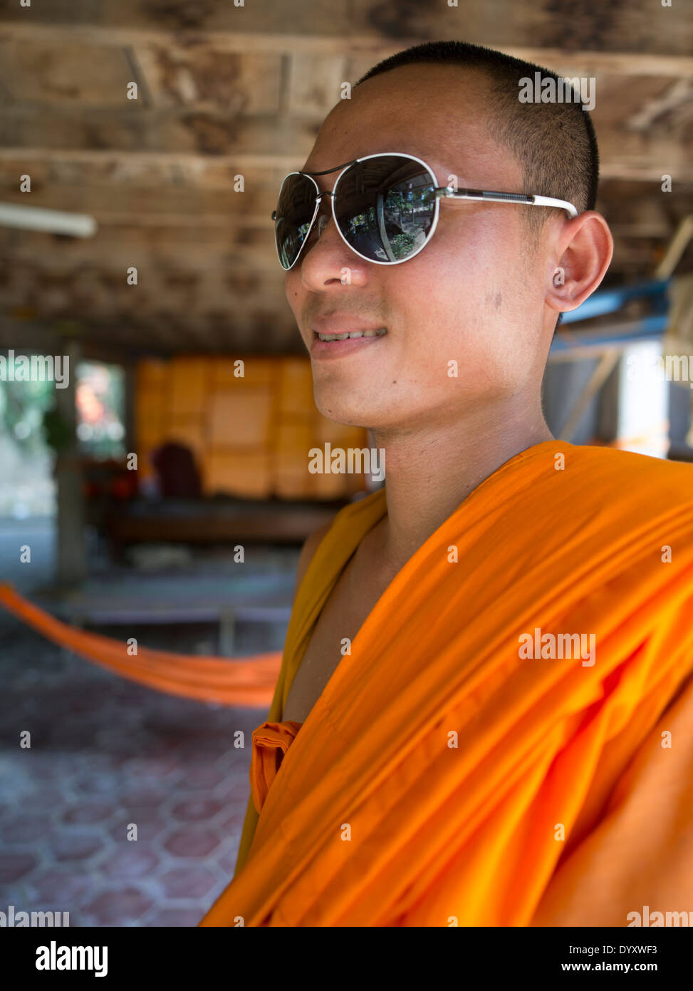 Young Buddhist monk in Ray Ban sunglasses at Wat Athvea Temple, Siem Reap, Cambodia Stock Photo