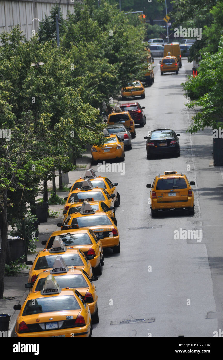 Manhattan street lined with yellow cabs. Stock Photo