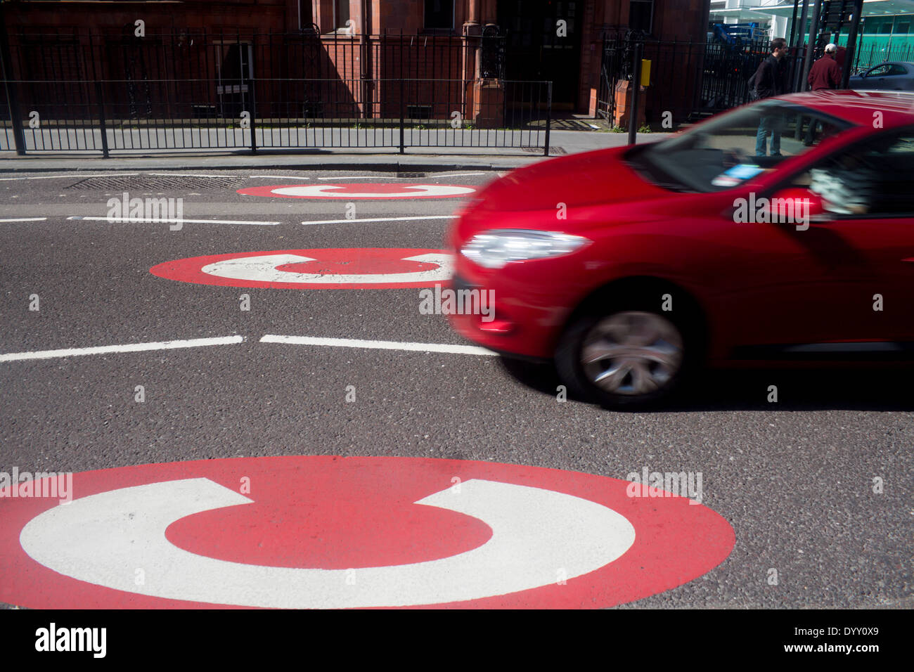 Congestion charge signs Red car crossing into Central London traffic congestion zone Gower Street London England UK Stock Photo