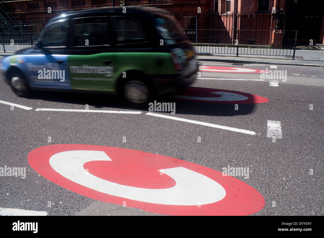 Congestion charge signs Black taxi cab car crossing into Central London traffic congestion zone Gower Street London England UK Stock Photo
