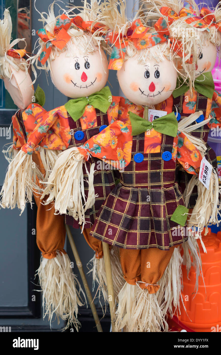 A display of toy rag doll garden ornaments made from straw and bright orange cloth Stock Photo