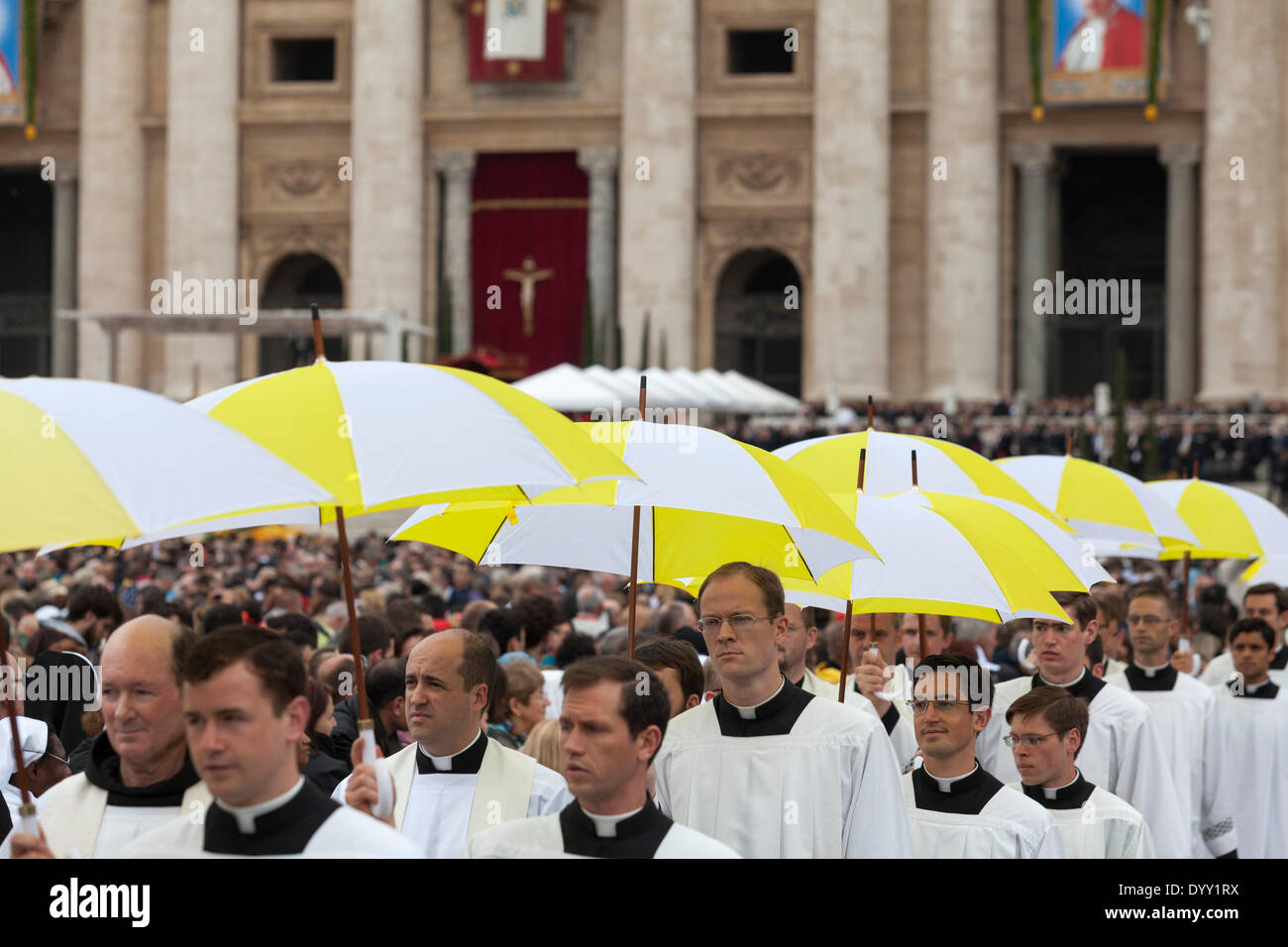 Procession of priest carrying umbrellas in St. Peter's Square Stock Photo