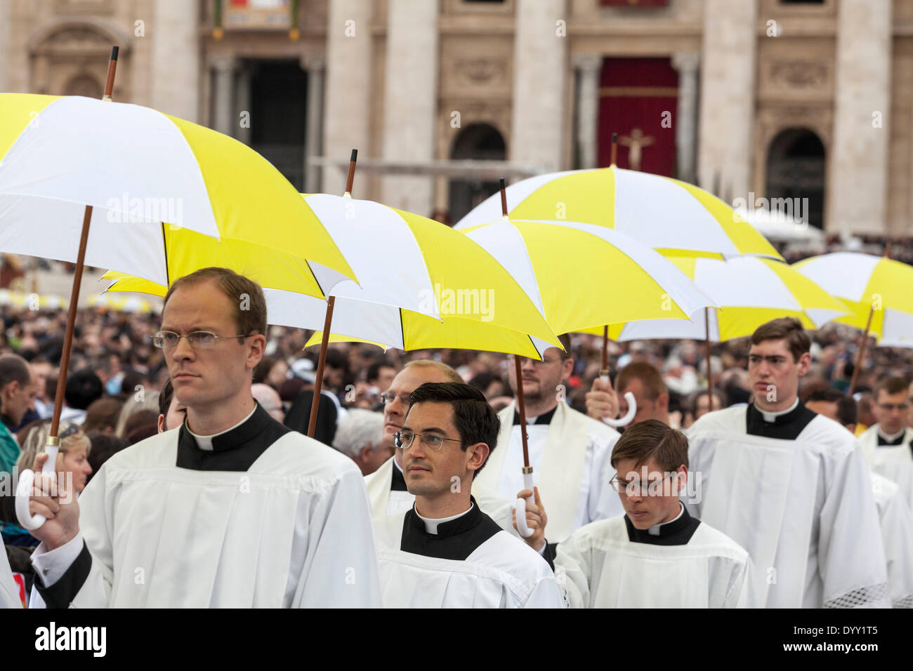 Procession of priest carrying umbrellas in St. Peter's Square Stock Photo
