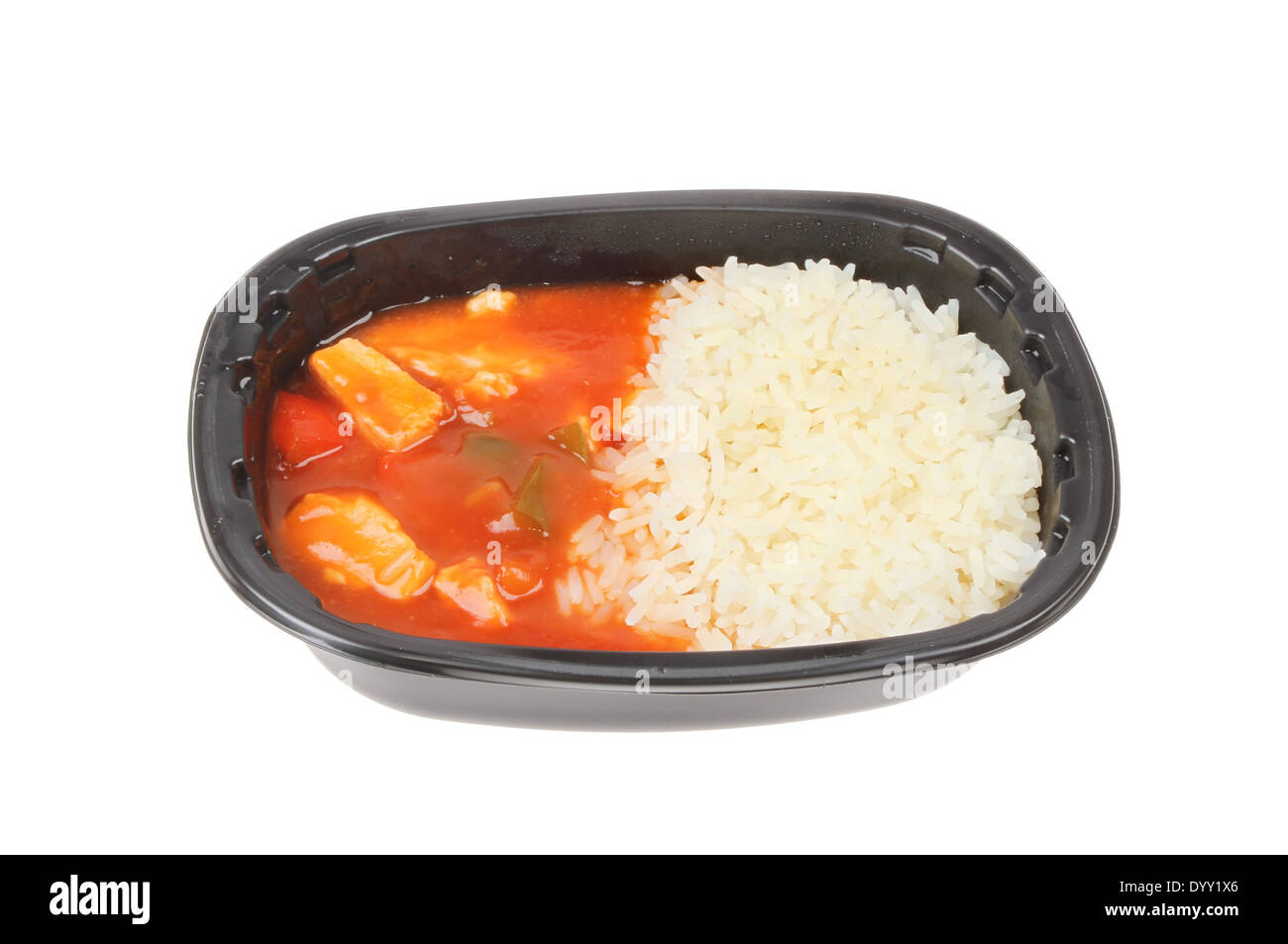 Convenience food, Chinese sweet and sour chicken and rice in a plastic carton isolated against white Stock Photo