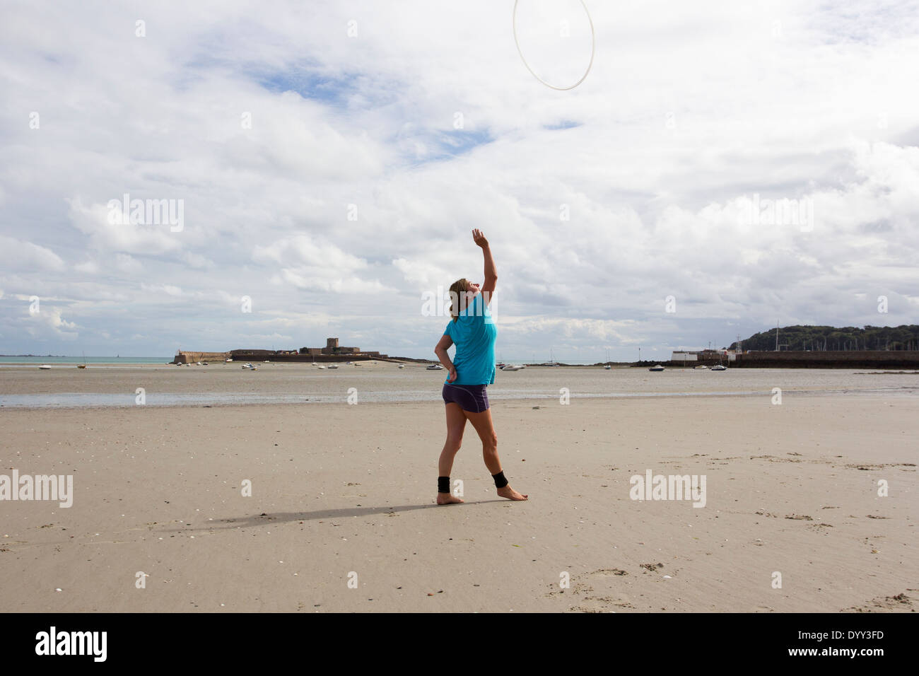 hula hoop work out exercise on the beach in Jersey The Channel Islands Stock Photo Alamy