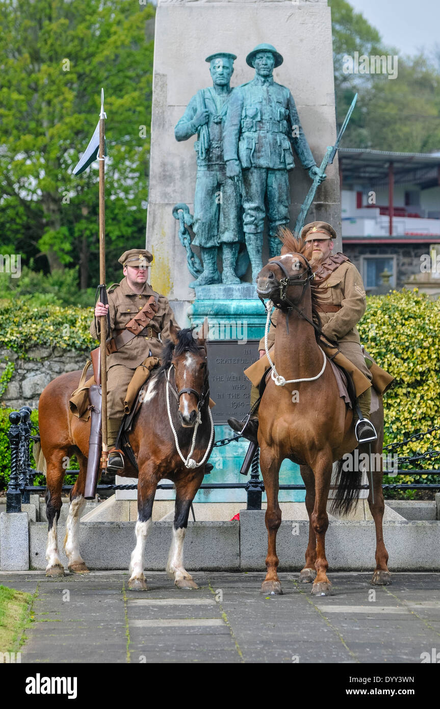 Two men dressed as WW1 soldiers from the Ulster Volunteers (UVF) on horseback at a war memorial. Stock Photo