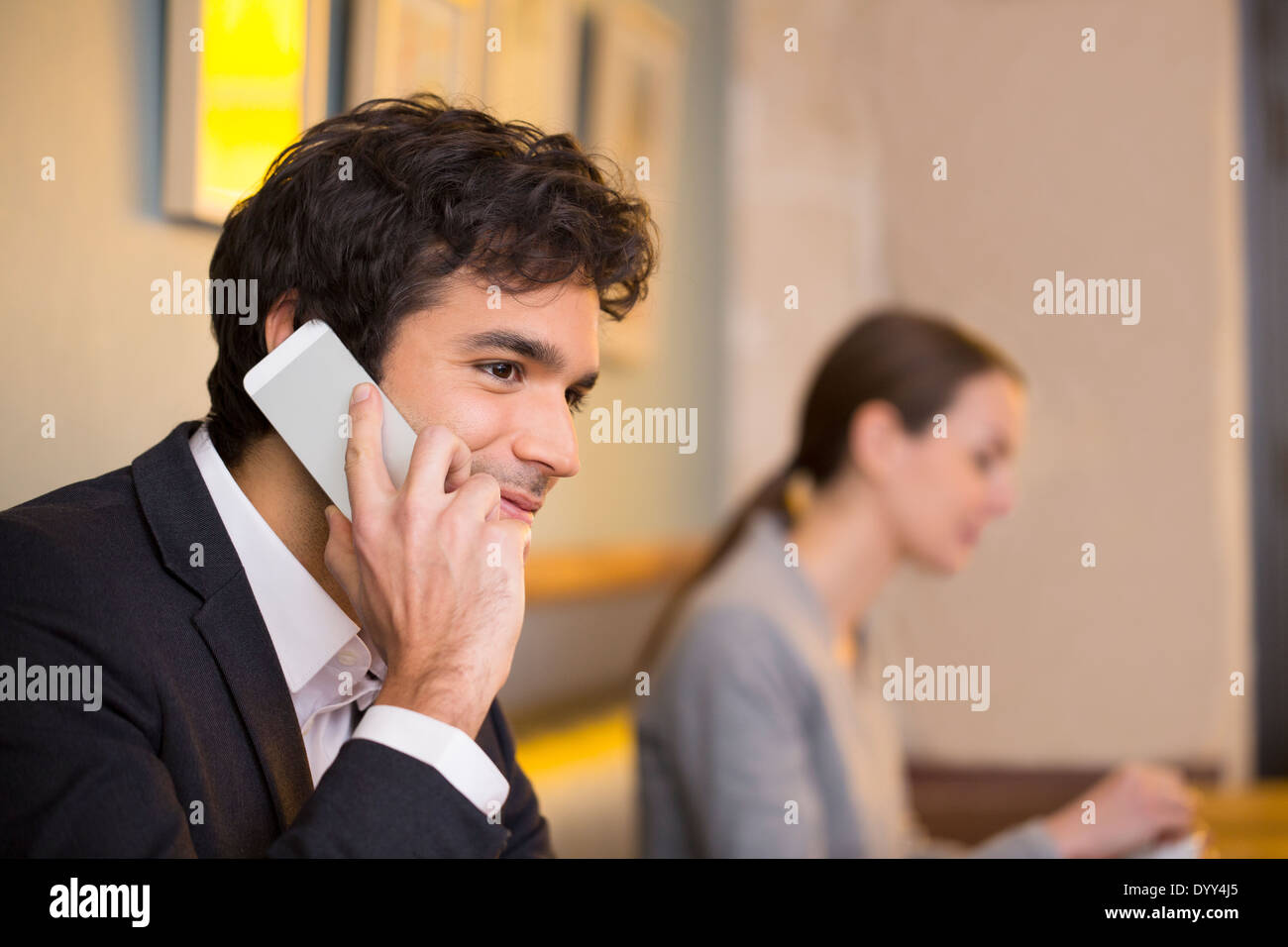 male cheerful calling restaurant smartphone cafe female tablet pc Stock Photo
