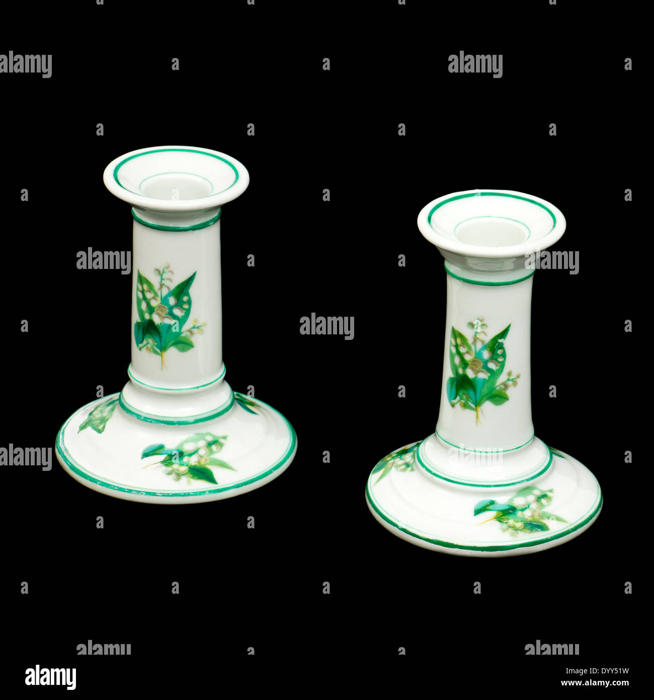 Pair of antique Victorian porcelain candlesticks, transfer illustrated with Lillies of the Valley Stock Photo