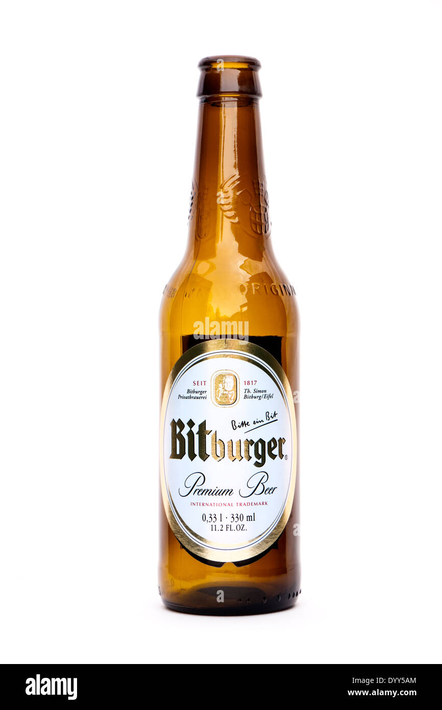 Bottle of Bitburger Premium German Pilsner (Lager), with their famous slogan 'Bitte ein Bit' on the label. Stock Photo