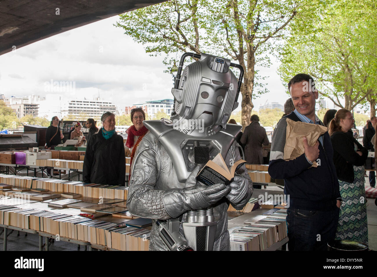 London, 27 April 2014 - people dressed as their favourite sci-fi characters take part in the Sci-Fi London 2014 costume parade starting at Somerset House and finishing at the BFI on the South Bank.  A cyberman reads a book at the book market underneath Waterloo Bridge.    Credit:  Stephen Chung/Alamy Live News Stock Photo
