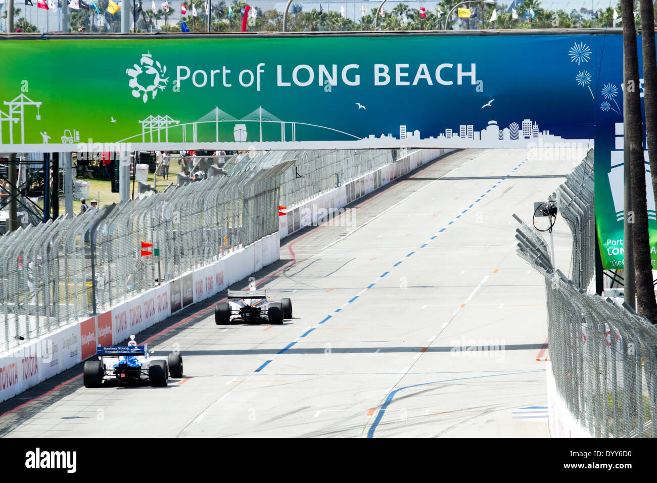 Two Indy cars race down Shoreline Drive underneath the Port of Long
