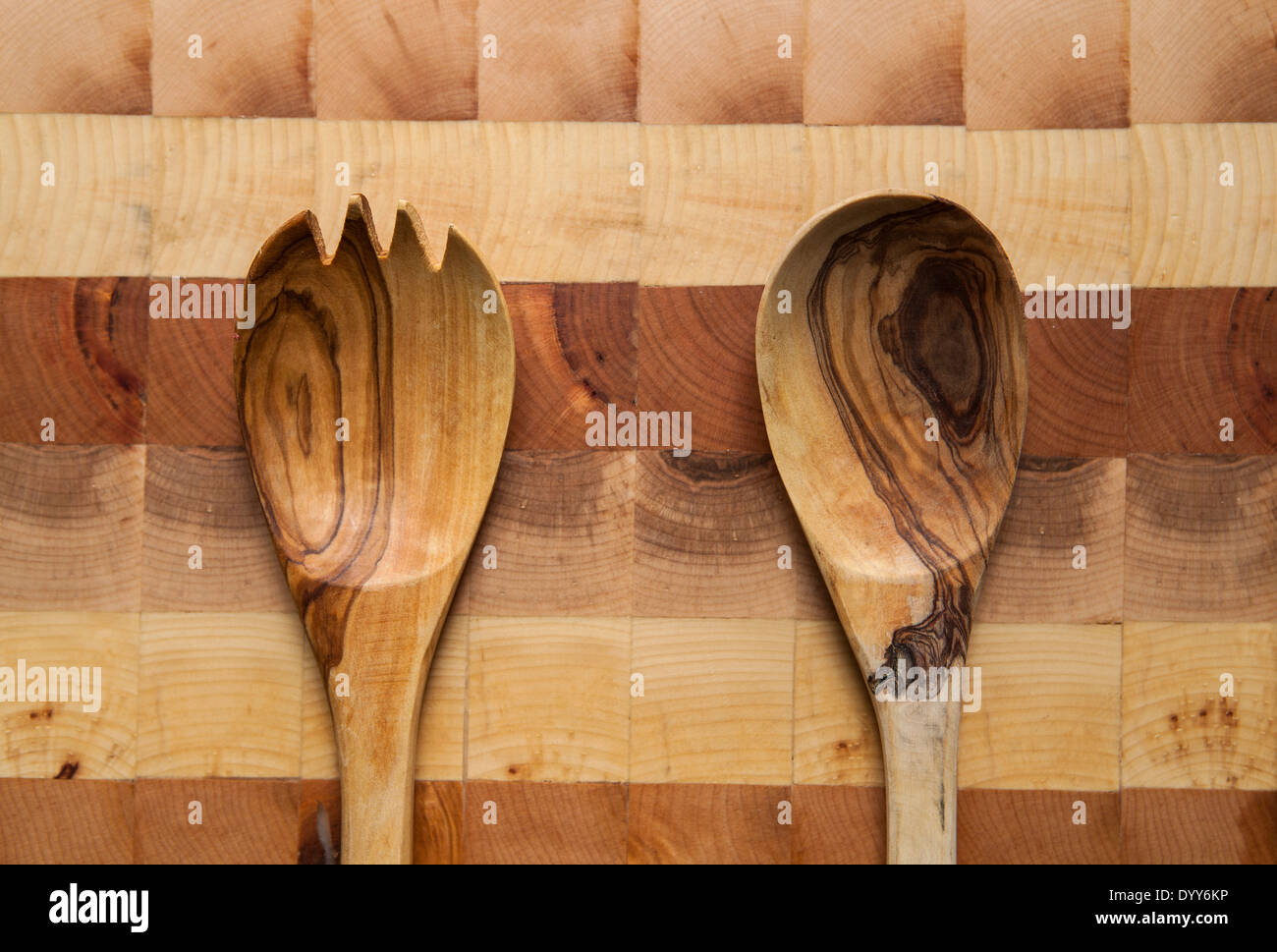 Wooden utensils on an end grain cutting board Stock Photo